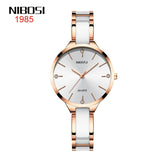NIBOSI rose gold and white ceramic bracelet watch with crystal hour markers, front view