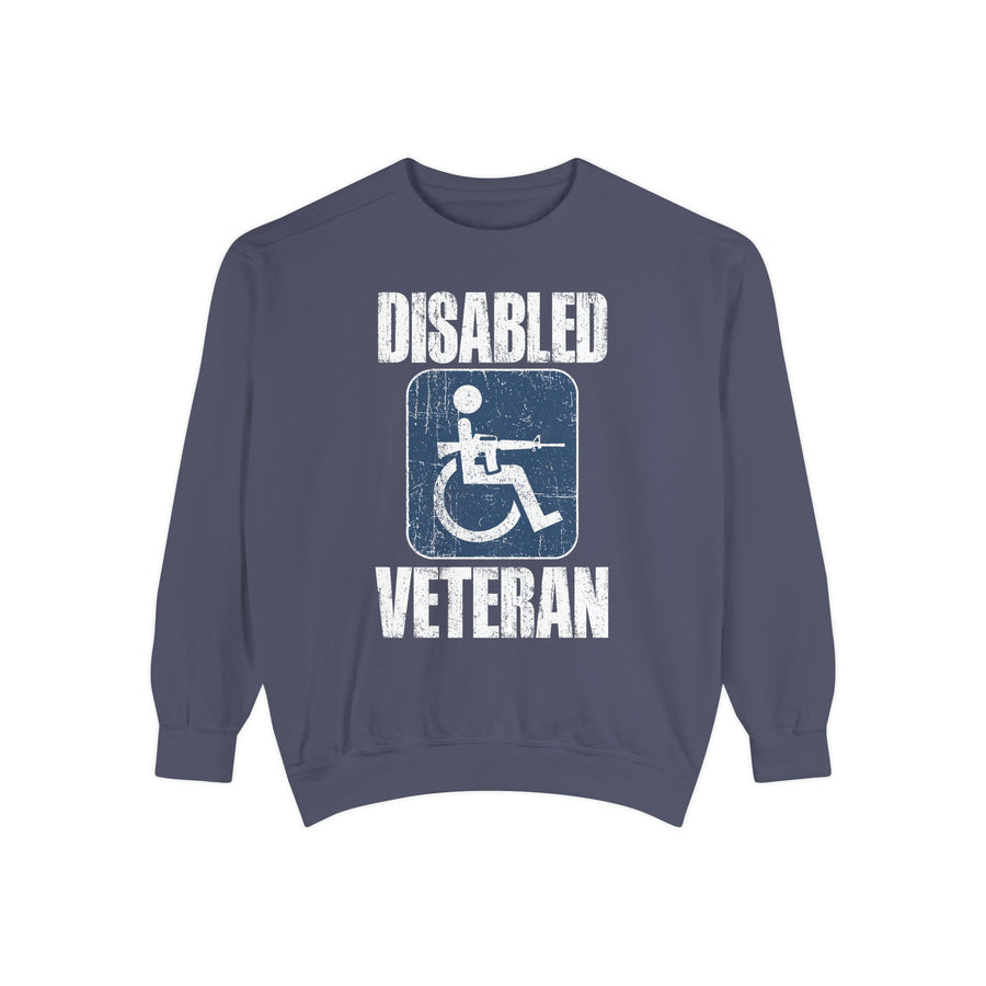 A blue crewneck sweatshirt printed with a distressed accessibility-symbol figure holding a rifle between Disabled and Veteran.
