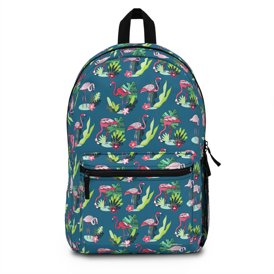 A backpack with black top handle, front zip pocket and mesh side pocket, covered in an all-over print of pink flamingos, green tropical leaves and pink flowers on a teal background.