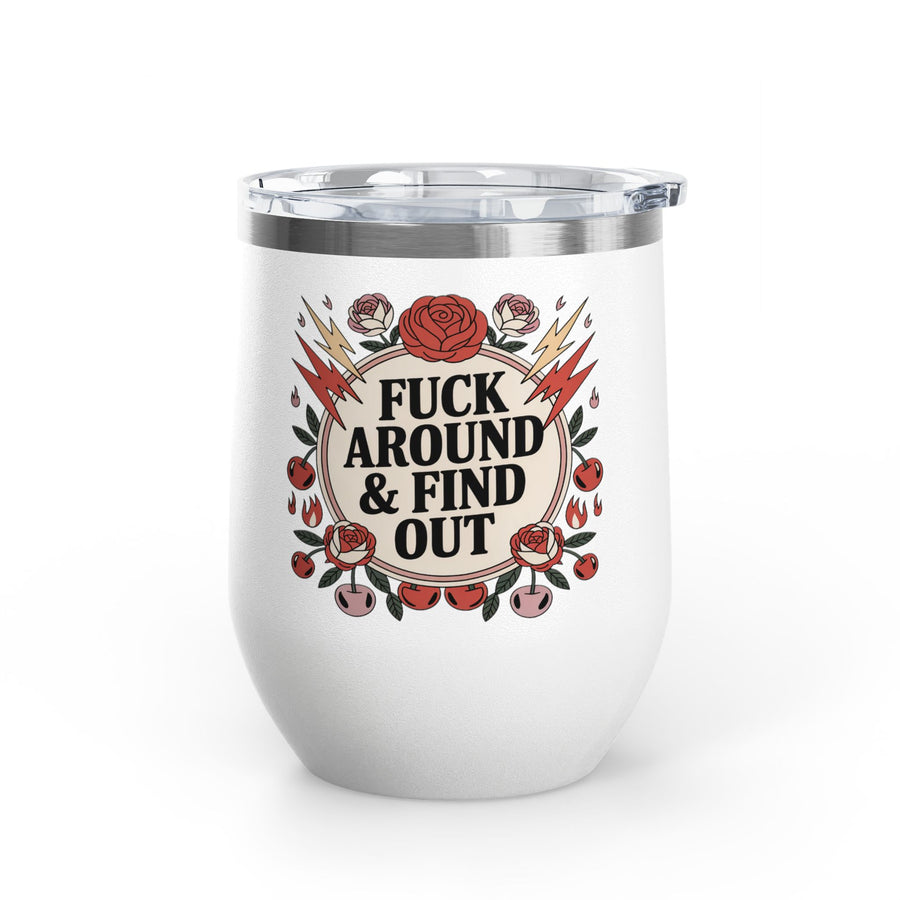 A white stainless steel stemless wine tumbler with a clear push-on lid, printed with a cheeky adult slogan ending "& FIND OUT" in bold black lettering on a cream circle, ringed by red roses, lightning bolts, flames and cherries.