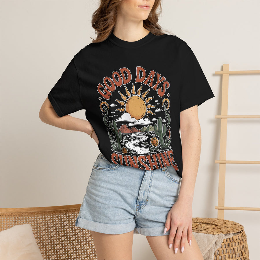 A black T-shirt printed with a retro desert scene of a sun, cacti and a winding road framed by the words Good Days Sunshine.