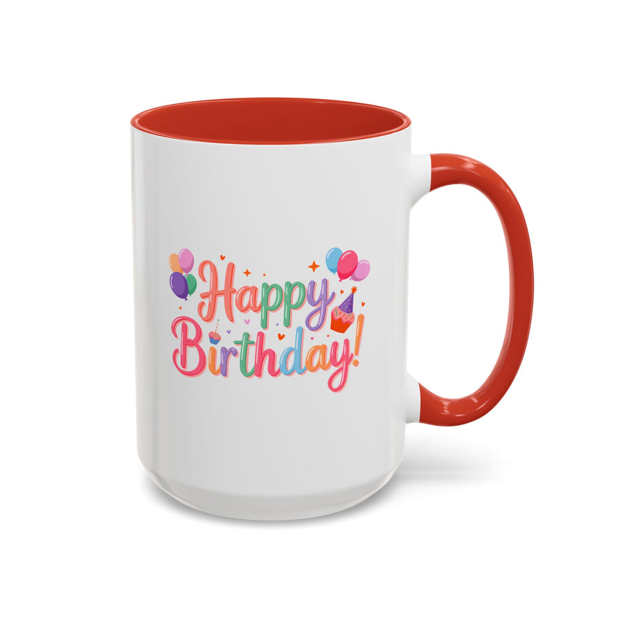 A white ceramic mug with a colored handle and interior, printed with "Happy Birthday!" in pastel rainbow script with bunches of balloons, a cupcake with a party hat, hearts and sparkles.