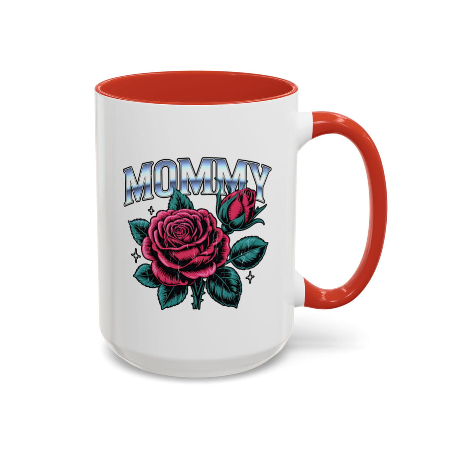 A white ceramic mug with a colored handle and interior, printed with "MOMMY" in silver-look block lettering above a large pink rose, a rosebud and teal leaves with small sparkles.