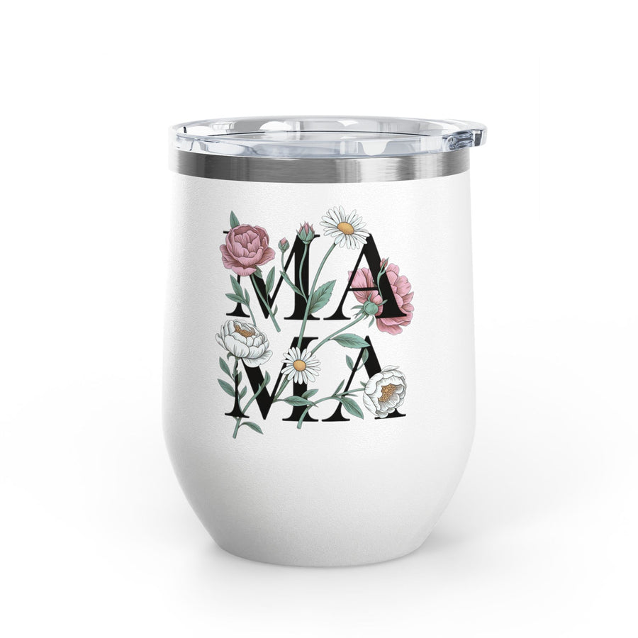 A white stainless steel wine tumbler with a clear push-on lid, printed with the word "MAMA" in black block letters decorated with pink roses and white daisies, in a garden setting.