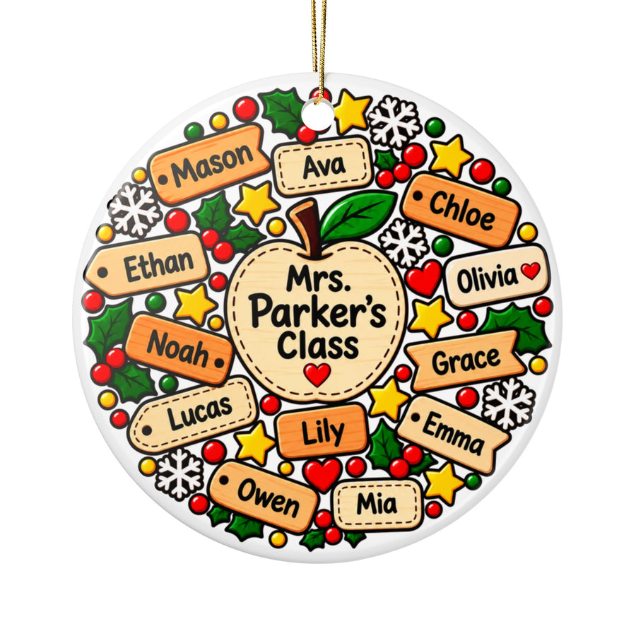 A round white ceramic Christmas ornament on a gold string, printed with a large apple reading a sample "Mrs. Parker's Class", ringed by orange and cream name tags with sample student names, holly, gold stars, snowflakes and red berries.