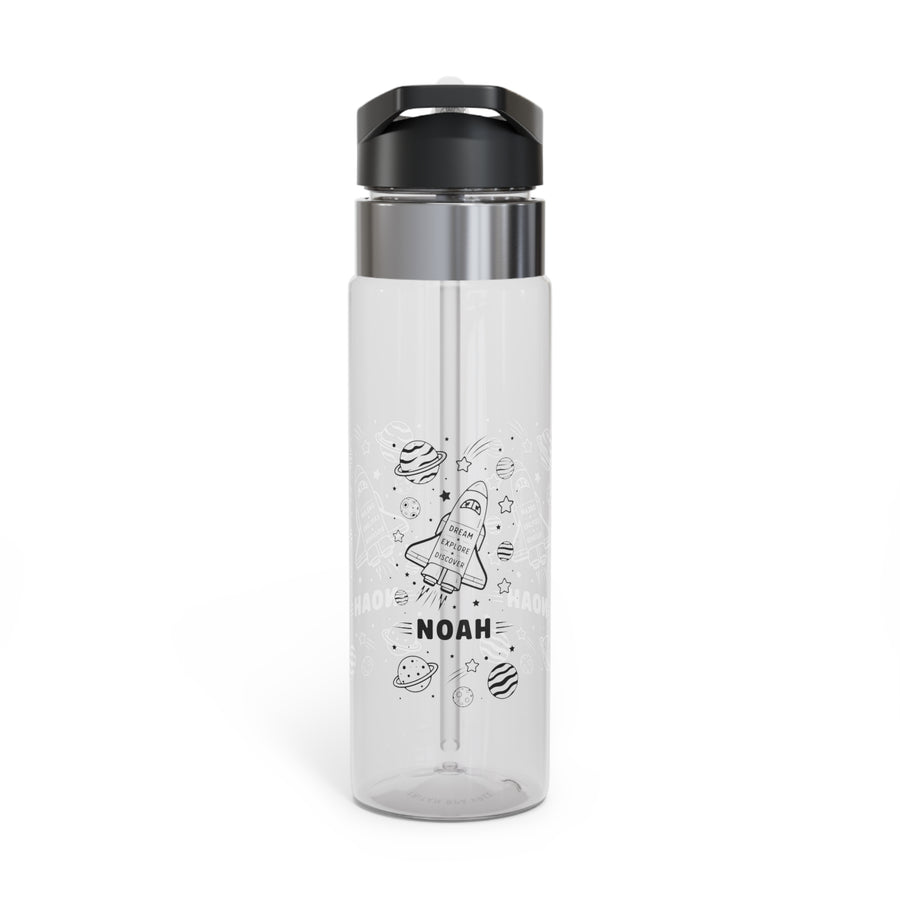 A clear Tritan water bottle with a black screw-on lid and straw, printed with rocket, planet, and star graphics and a name, styled with space-themed toys.