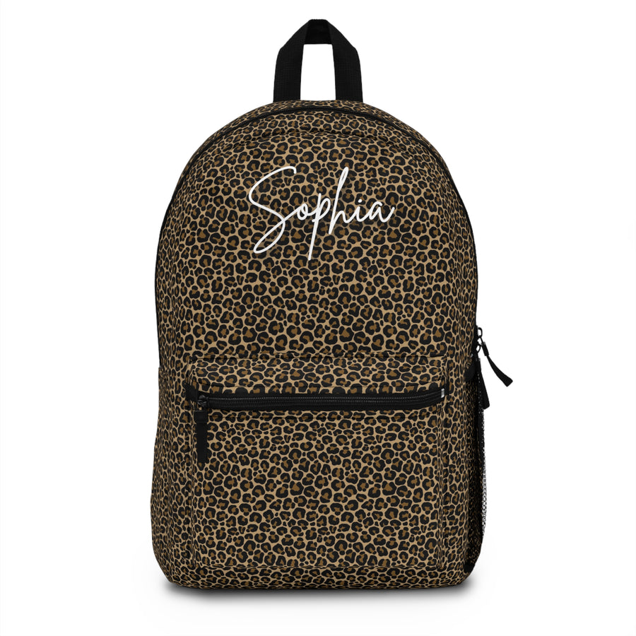 A backpack with black top handle, front zip pocket and mesh side pocket, covered in an all-over brown and black leopard print, with the sample name "Sophia" in white script across the top.
