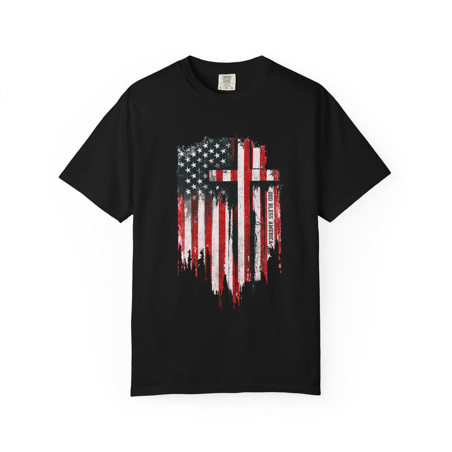 A cream T-shirt printed with a distressed American flag with two black crosses and the words God Bless America.