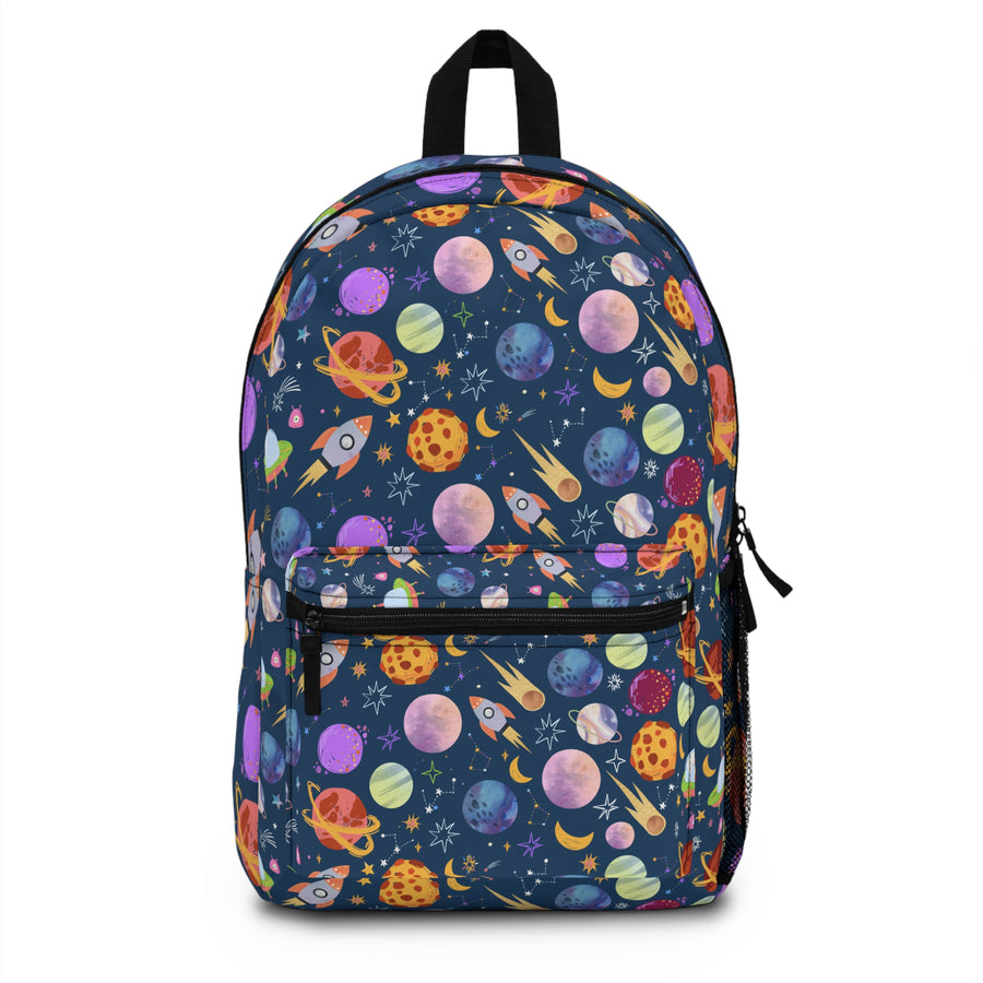 A backpack with black top handle, front zip pocket and mesh side pocket, covered in an all-over print of colorful planets, rockets, comets, moons and stars on a navy background.