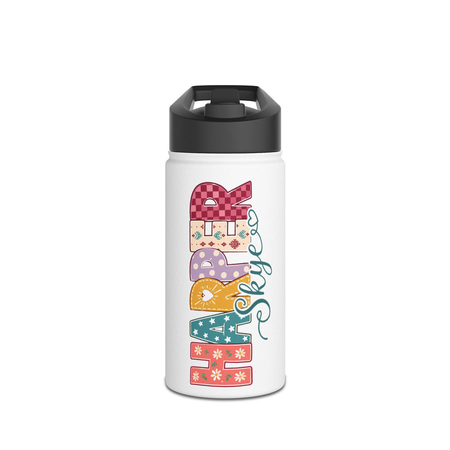 White water bottle with a black lid, printed with the word Happy reading downwards in patchwork applique letters of checks and florals, with the name Skye in teal script beside it.