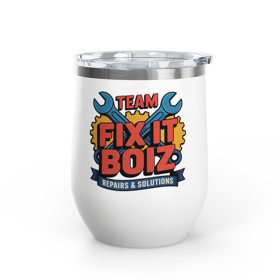 A white stainless steel stemless wine tumbler with a clear push-on lid, printed with "TEAM FIX IT BOIZ" in bold red lettering over crossed blue wrenches and yellow gears, above a "REPAIRS & SOLUTIONS" banner.