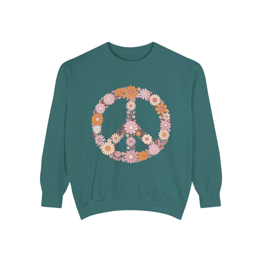 White sweatshirt printed with a large peace sign built entirely from retro daisies and blooms in dusty pink, apricot and cream, with curling leaves filling the centre of the ring.