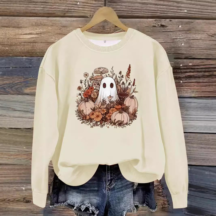 A red crewneck sweatshirt printed with a small ghost among pumpkins, mushrooms and autumn flowers.