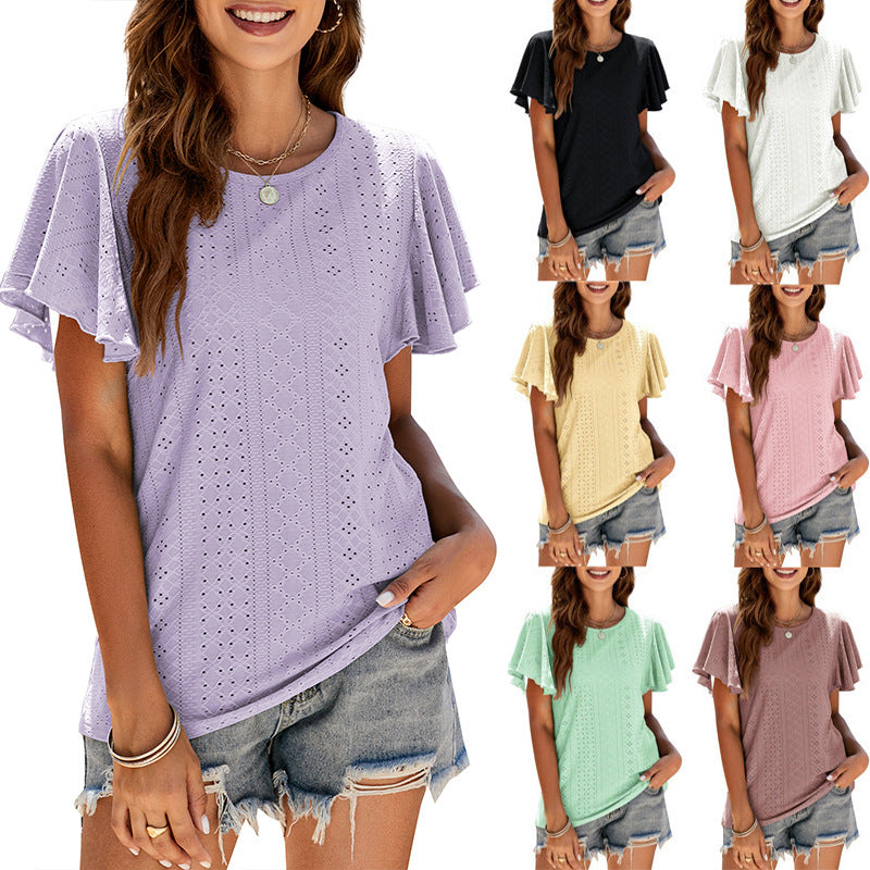 The same eyelet knit top shown in seven colourways, lilac, black, white, yellow, pink, mint and mauve, each with short flutter sleeves and a plain round neckline, each worn with frayed denim shorts.