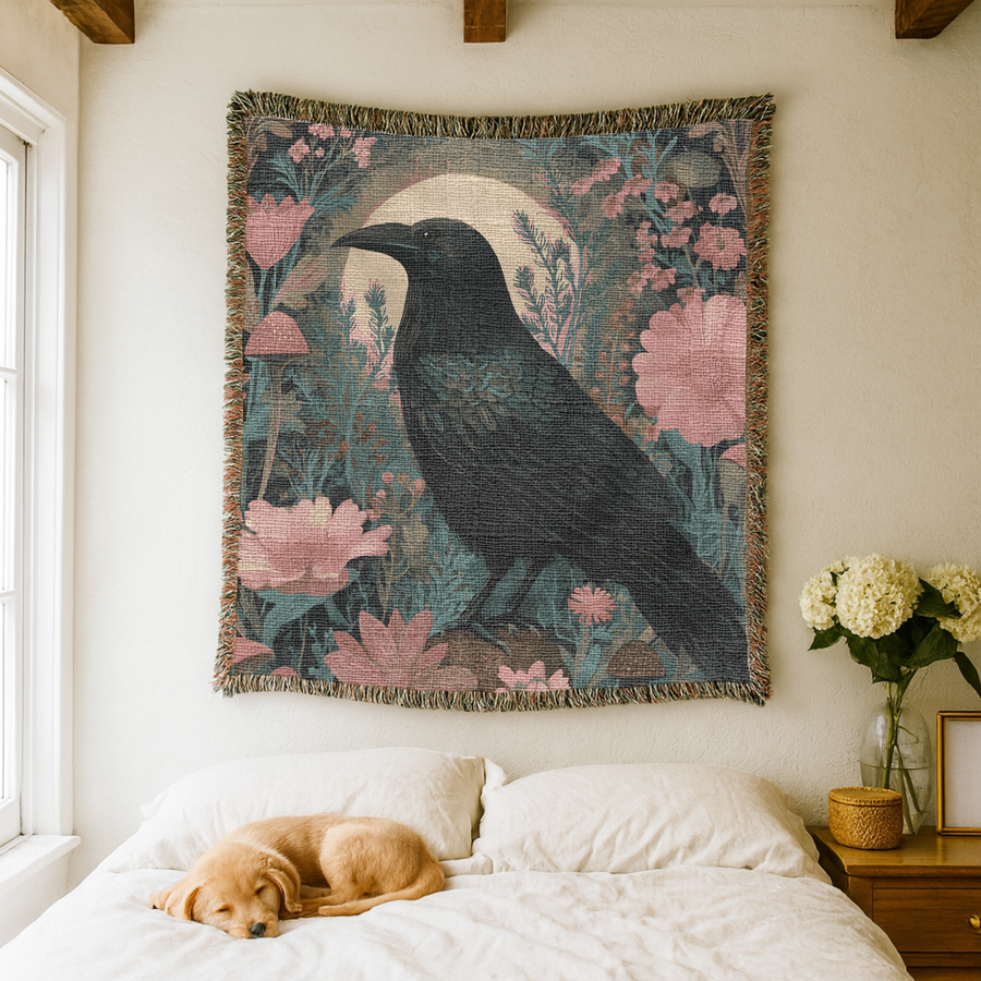 Fringed woven tapestry of a black crow standing in profile against a pale rising moon, surrounded by pink poppies, teal foliage and small brown mushrooms on a dark ground.