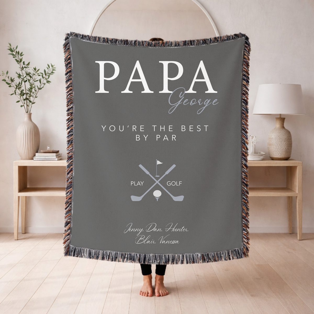 Grey fringed woven blanket reading Papa in large letters with George in script across them, above You're the Best by Par, crossed golf clubs over a ball on a tee, and five names.