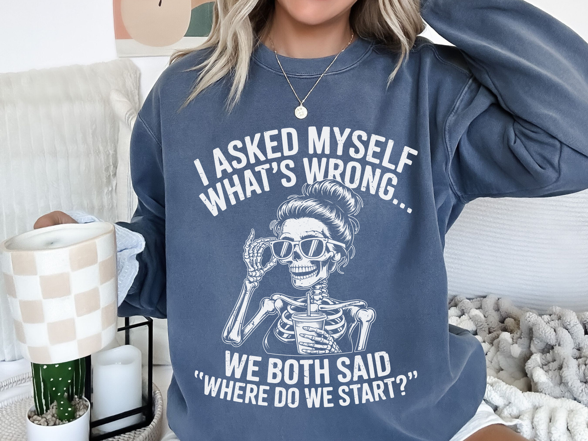 A blue crewneck sweatshirt printed with a skeleton in sunglasses between I asked myself what's wrong and We both said where do we start?