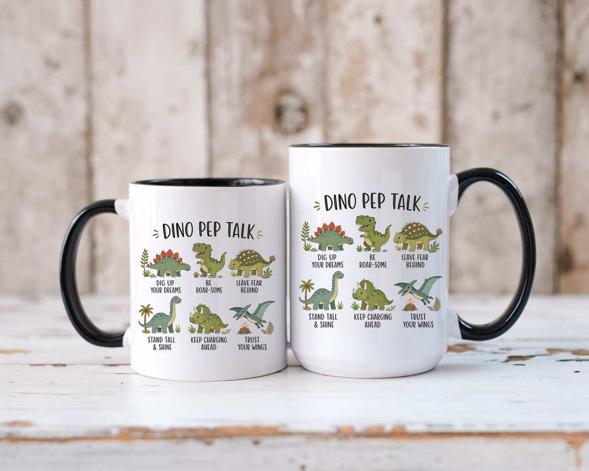 Two white mugs with black handles and interiors standing side by side, both printed Dino Pep Talk with six cartoon dinosaurs captioned Be Roar-Some, Stand Tall and Shine and more.