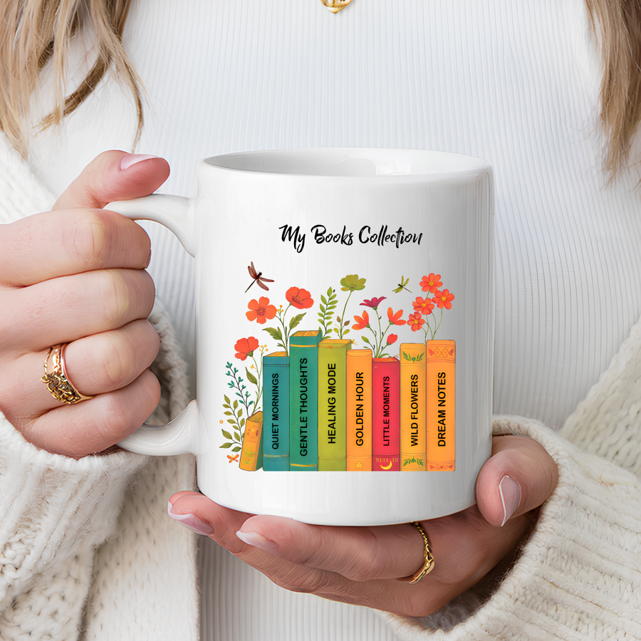 White mug headed My Books Collection, printed with a row of coloured book spines reading Quiet Mornings, Gentle Thoughts, Healing Mode and more, with orange flowers and dragonflies.