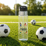 Clear plastic water bottle with a black flip lid and a straw, printed with the name Theo in navy block capitals among four cartoon boys in football kits running with balls.
