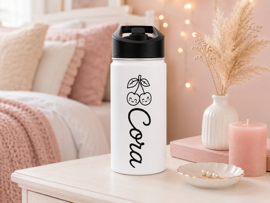 White water bottle with a black lid, printed with a line-drawn pair of cherries with smiling faces above the name Cora, both in black and reading downwards along the bottle.