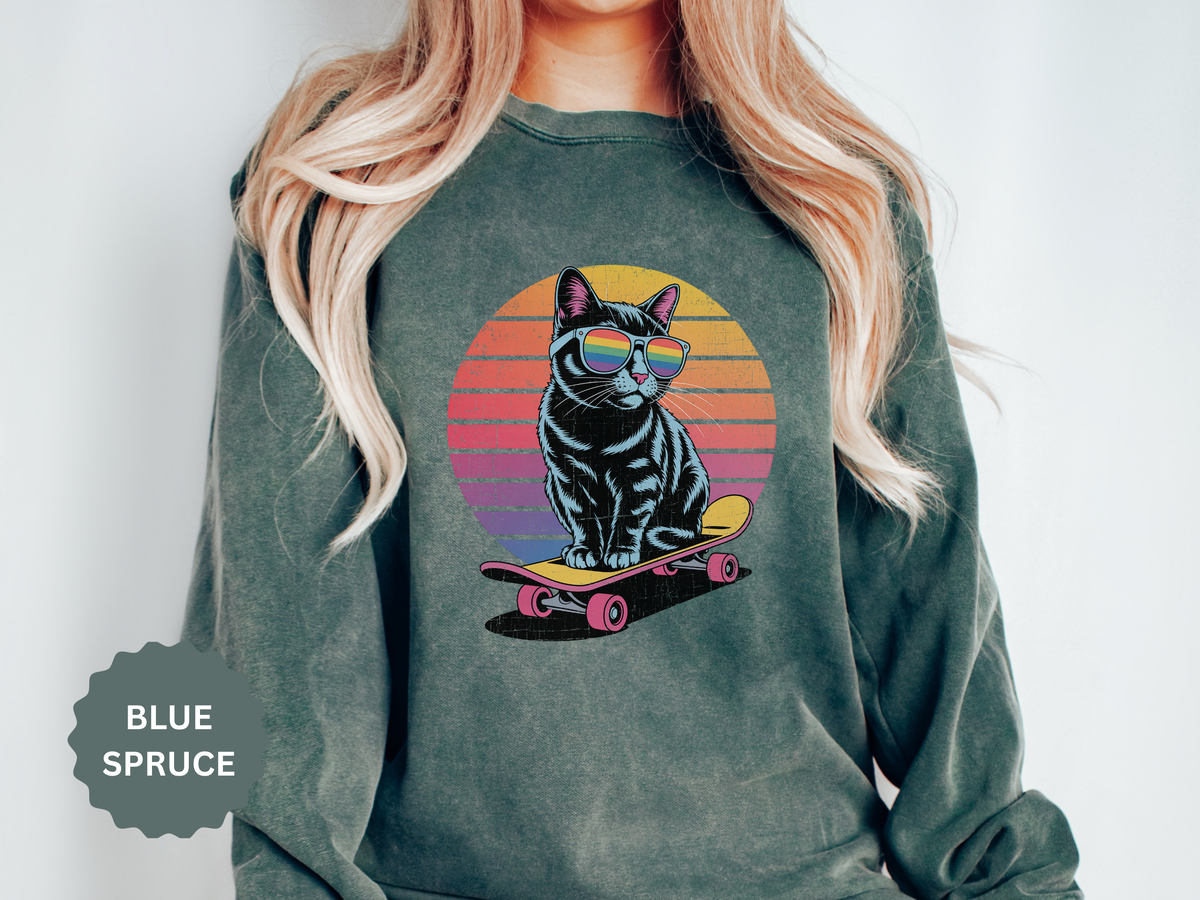 A green crewneck sweatshirt printed with a black cat in sunglasses riding a skateboard in front of a retro striped sunset.