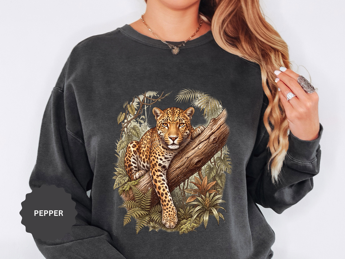 A dark gray crewneck sweatshirt printed with a leopard lounging on a tree branch surrounded by jungle leaves.