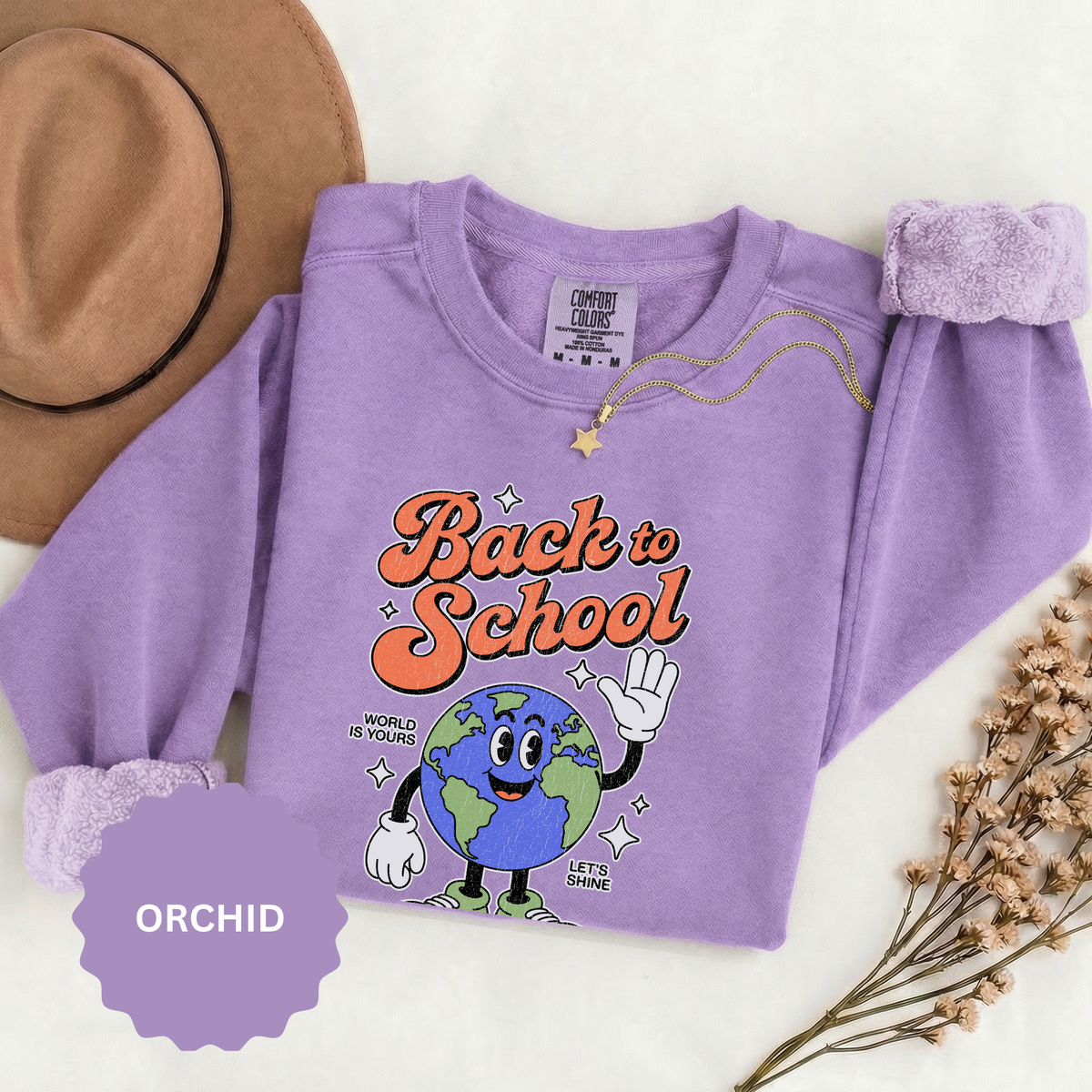 A purple crewneck sweatshirt printed with a waving cartoon globe in sneakers under Back to School in orange script.