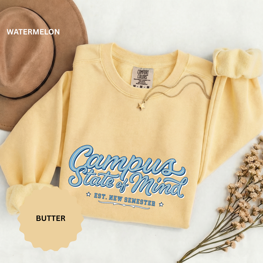 A pale yellow crewneck sweatshirt printed with Campus State of Mind in blue script and Est. New Semester.