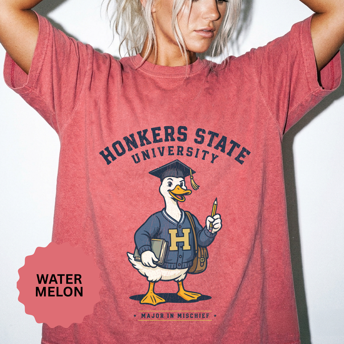 A red T-shirt printed with a goose in a graduation cap and varsity sweater holding a pencil under Honkers State University and Major in Mischief.