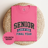 A pink T-shirt printed with SENIOR in navy and gold varsity letters above Class of 2026 and Final Year.