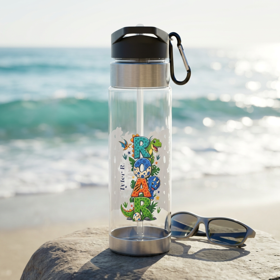 Clear plastic water bottle with a black flip lid and a straw, printed with the word Roar spelled out in cartoon dinosaur letters, with the name Tyler R. in black script alongside them.