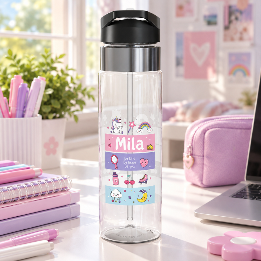 A clear water bottle with a black screw-on lid and handle, printed with colorful striped bands featuring a unicorn, a rainbow, the personalized name Mila, and the words Be Kind Be Brave Be You.