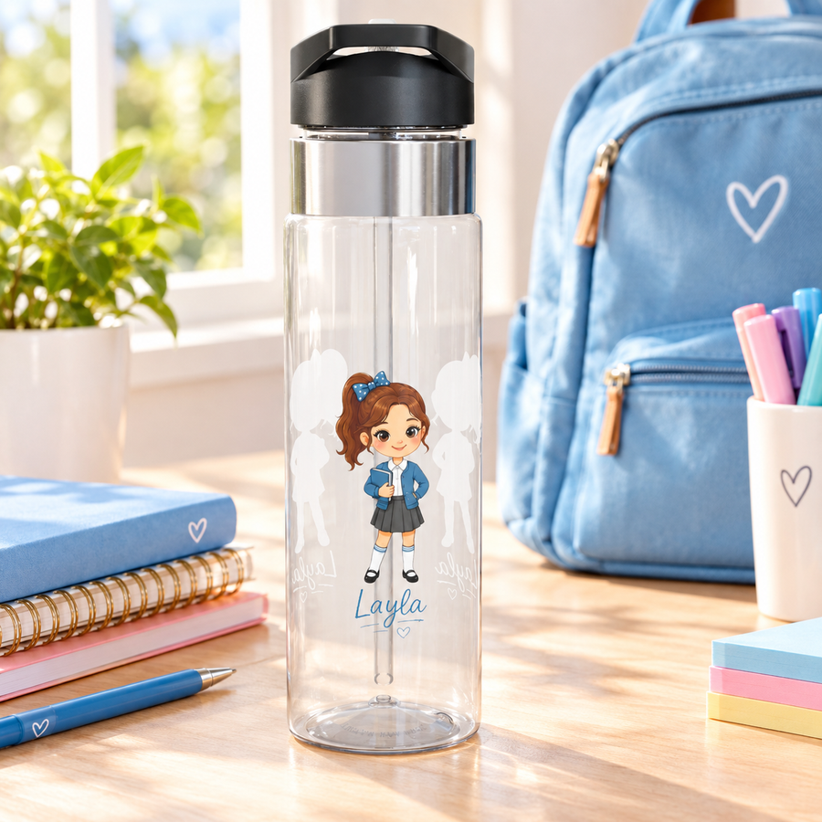 A clear Tritan water bottle with a black screw-on lid and straw, printed with a blue elementary-school-girl design and a name, styled with school supplies.