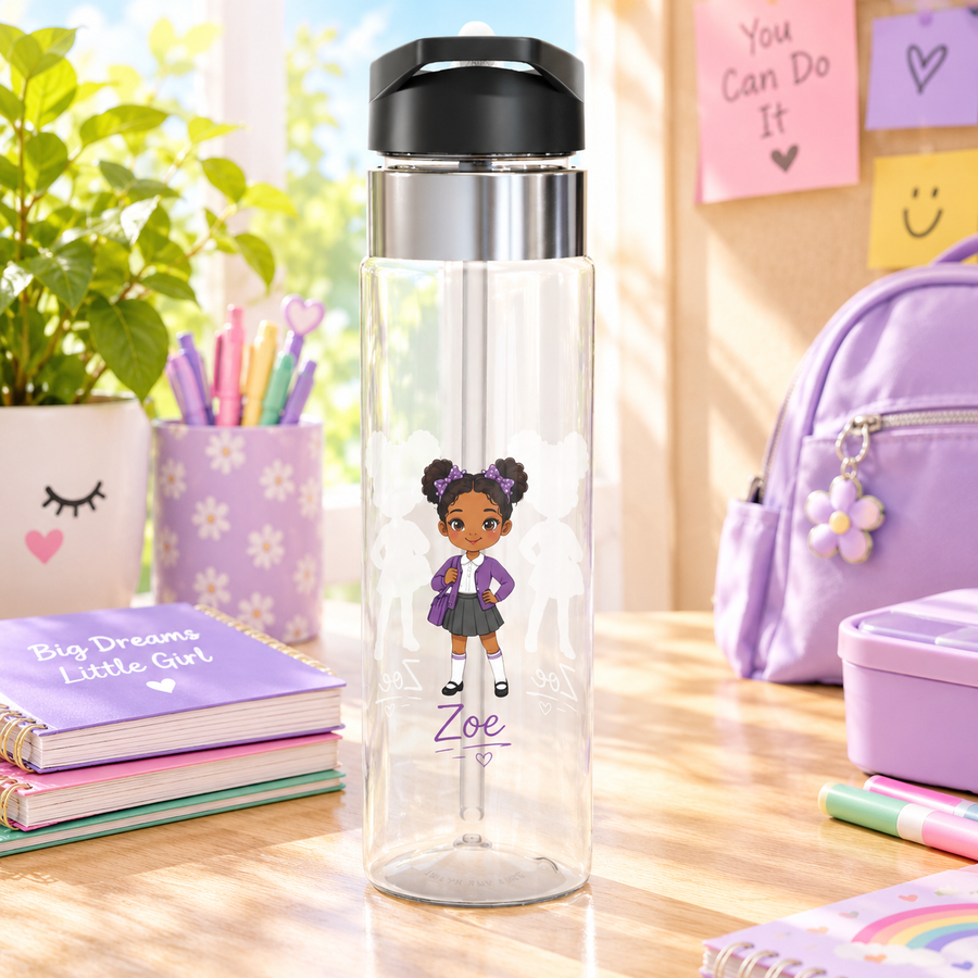 A clear Tritan water bottle with a black screw-on lid and straw, printed with a purple elementary-school-girl design and a name, styled with school supplies.