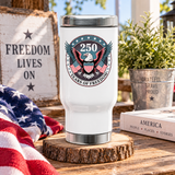 White stainless steel travel mug printed with an eagle emblem and a circular badge reading '250 Years of Freedom' with crossed American flags.