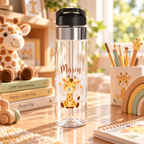 A clear water bottle with a black flip-top lid, stainless band and straw, printed with the sample name "Mason" in orange above a smiling cartoon baby giraffe with small hearts.
