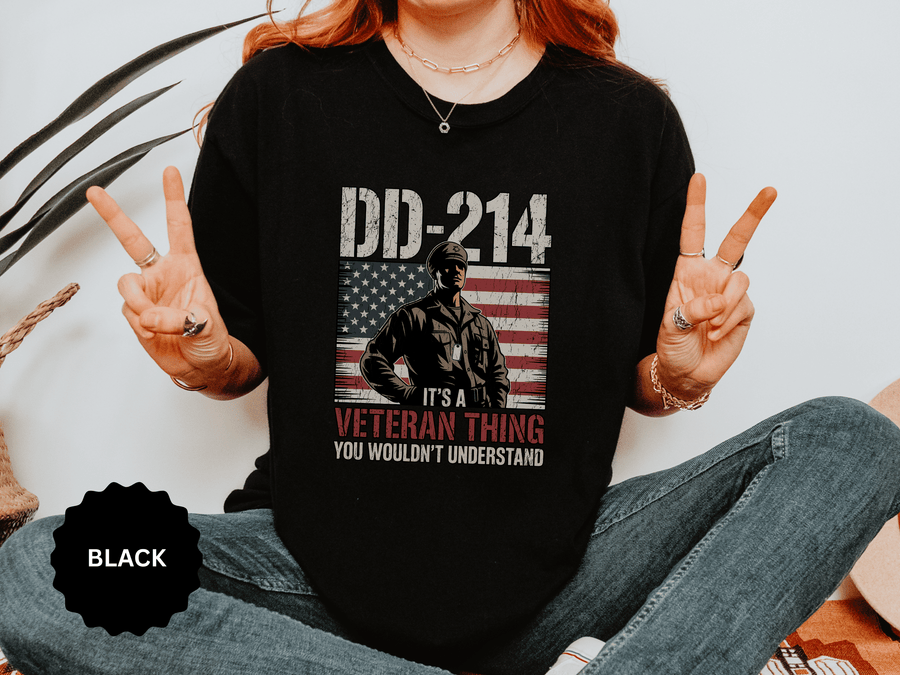 A woman wearing a black t-shirt printed with DD-214 above a soldier in front of an American flag and It's a Veteran Thing, You Wouldn't Understand.