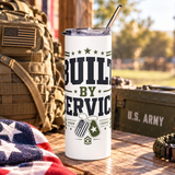 A white stainless steel skinny tumbler with a clear lid and metal straw, printed with "BUILT BY SERVICE" in black and olive lettering with stars, two dog tags and the words Honor and Courage.