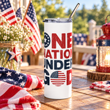 A white stainless steel skinny tumbler with a clear lid and metal straw, printed with "ONE NATION UNDER GOD" in distressed red and navy lettering with a star circle and an American flag in the O.