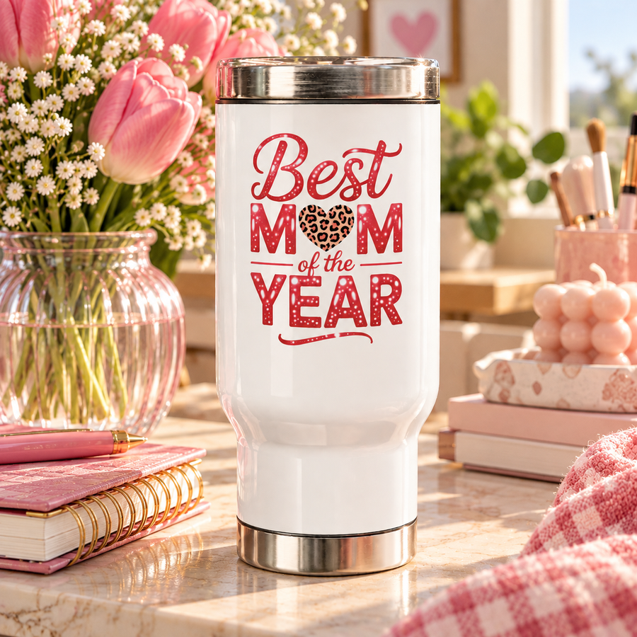A white stainless steel travel mug with a silver lid and base, printed with "Best MOM of the YEAR" in red sparkle lettering with a leopard-print heart.