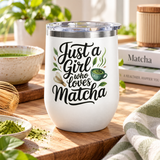 A white stainless steel stemless wine tumbler with a clear push-on lid, printed with "Just a Girl who Loves Matcha" in black script with a green matcha bowl, a bamboo whisk and tea leaves.