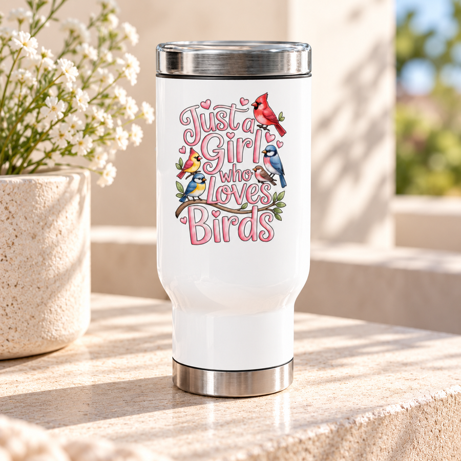 A white stainless steel travel mug with a silver lid and base, printed with "Just a Girl who Loves Birds" in pink bubble lettering with a cardinal, a blue jay, goldfinches and finches on a branch.