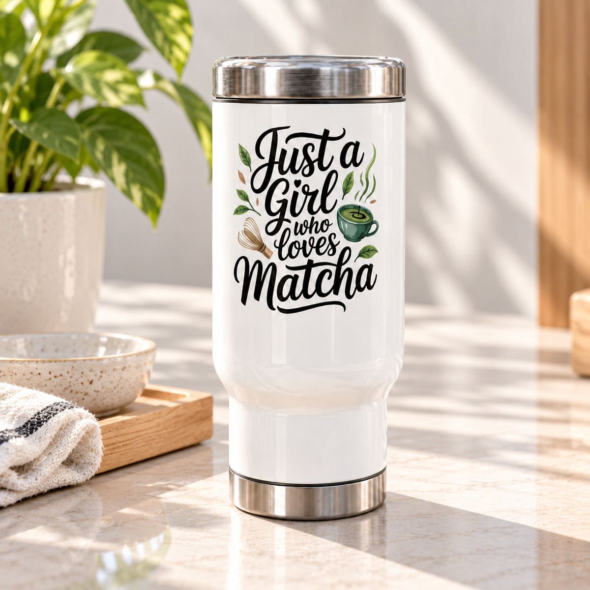 A white stainless steel travel mug with a silver lid and base, printed with "Just a Girl who Loves Matcha" in black script with a green matcha bowl, a bamboo whisk and tea leaves.