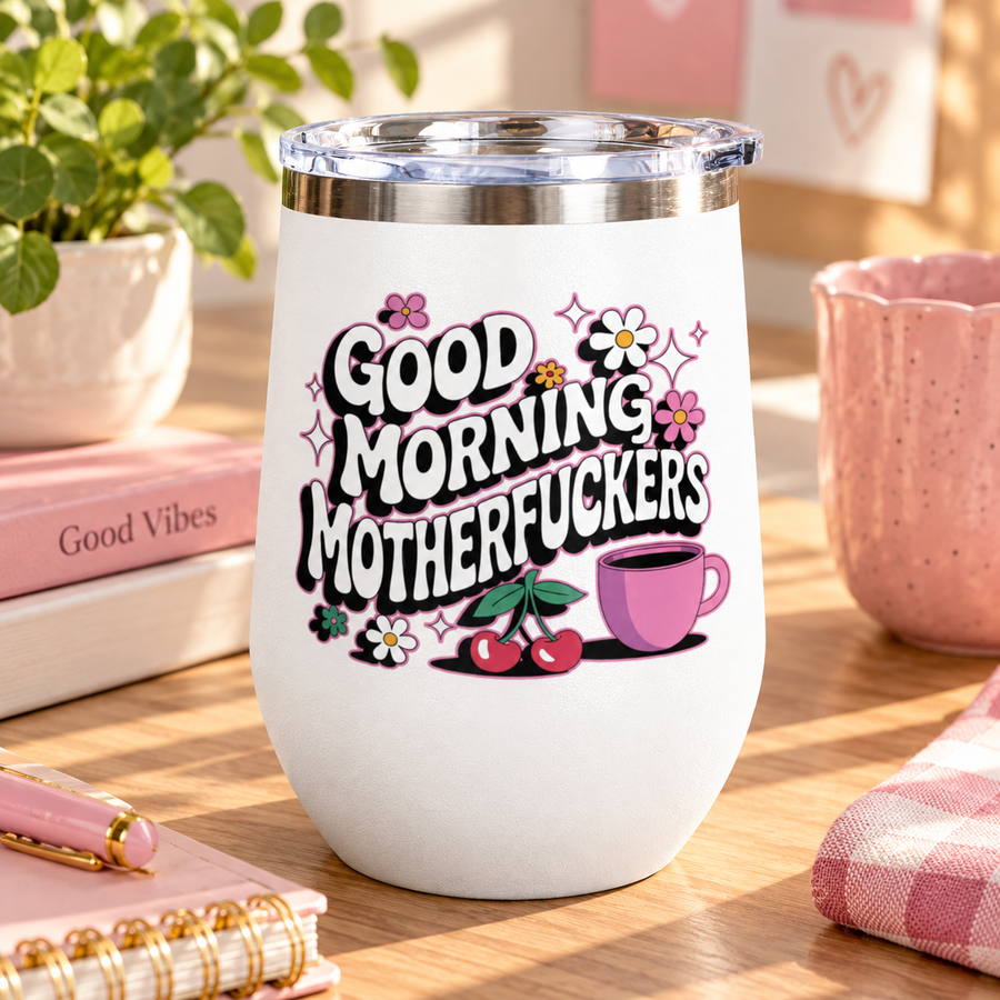A white stainless steel stemless wine tumbler with a clear push-on lid, printed with "GOOD MORNING" and a cheeky adult slogan in retro bubble lettering with daisies, cherries, sparkles and a pink coffee cup.