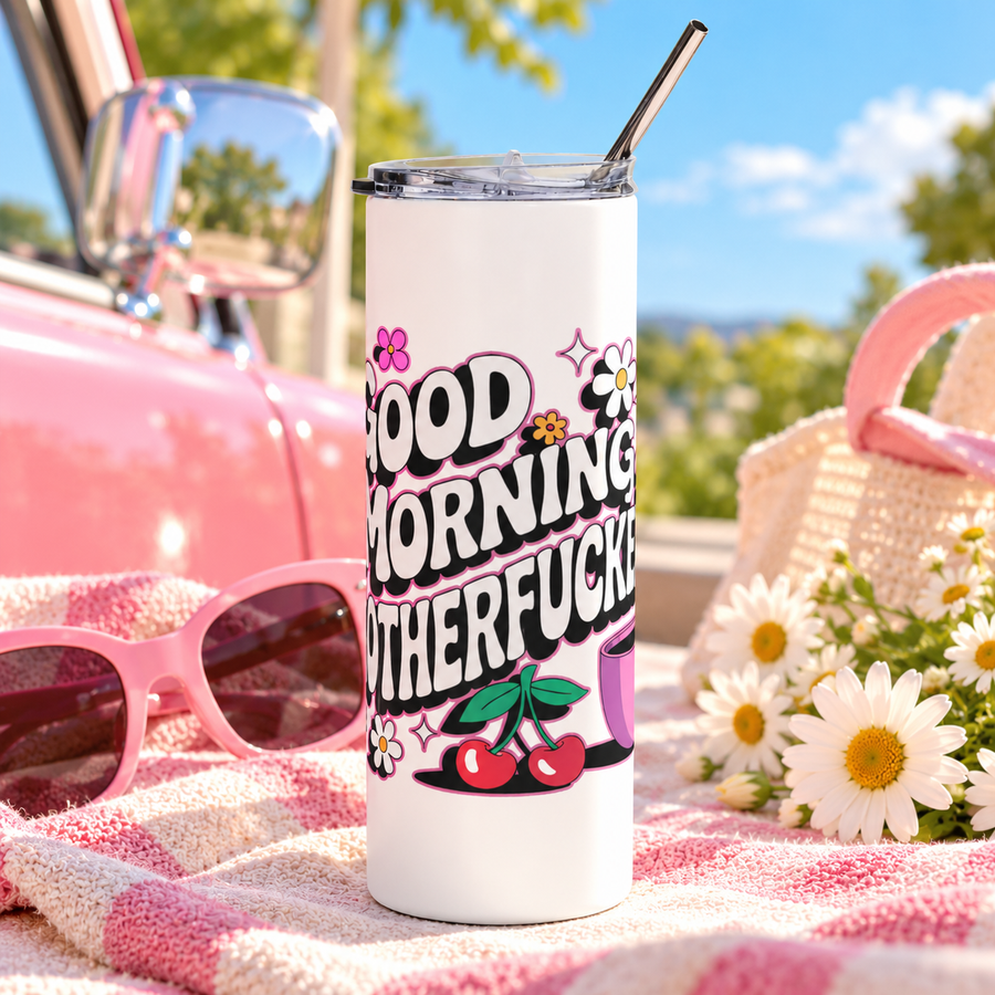 A white stainless steel skinny tumbler with a clear lid and metal straw, printed with "GOOD MORNING" and a cheeky adult slogan in retro bubble lettering with daisies, cherries, sparkles and a pink coffee cup.