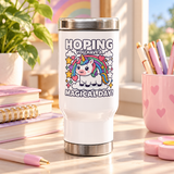 A white stainless steel travel mug with a silver lid and base, printed with "HOPING YOU HAVE A MAGICAL DAY!" around a cute unicorn on a cloud under a rainbow with stars and hearts.
