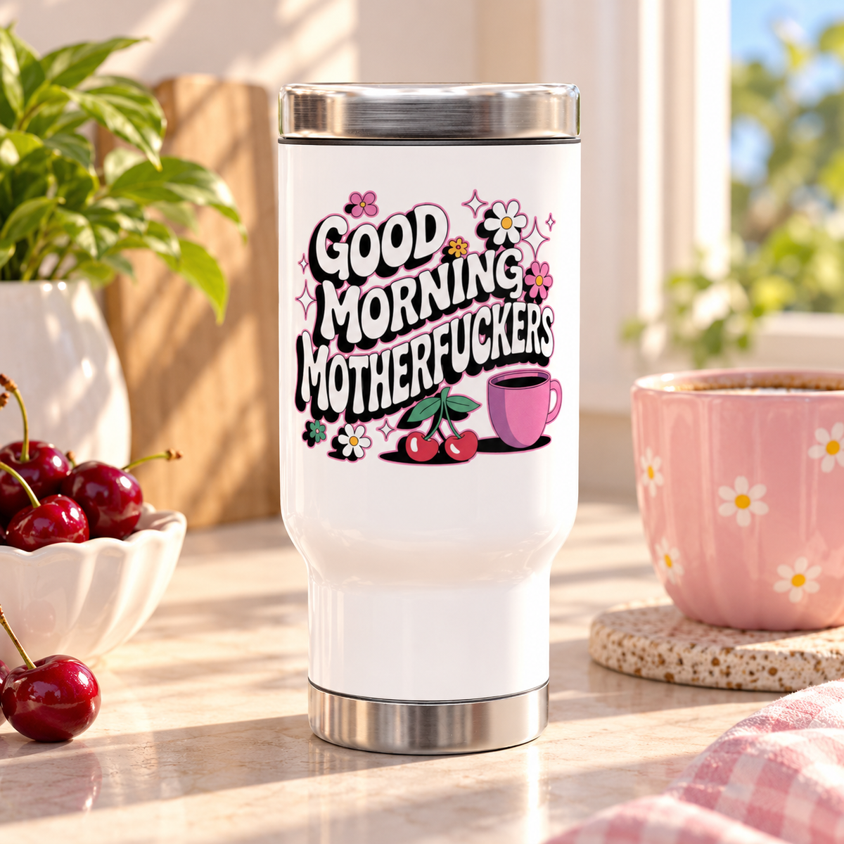 A white stainless steel travel mug with a silver lid and base, printed with "GOOD MORNING" and a cheeky adult slogan in retro bubble lettering with daisies, cherries, sparkles and a pink coffee cup.