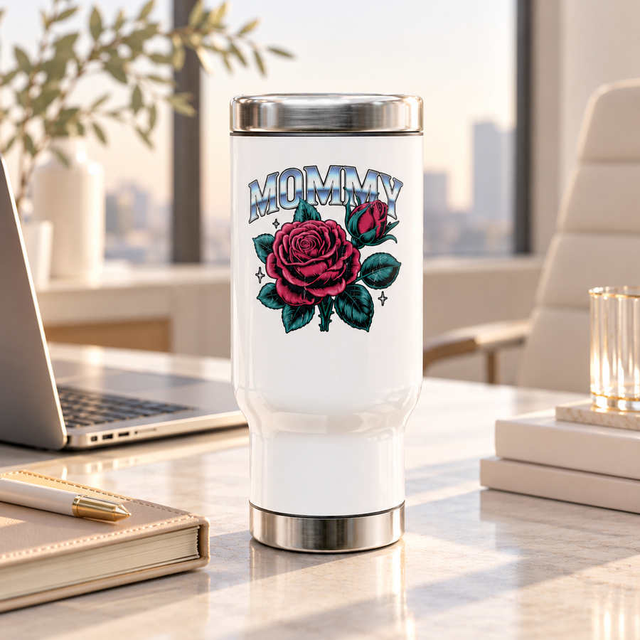 A white stainless steel travel mug with a silver lid and base, printed with "MOMMY" in chrome-style block lettering above a large pink rose and rosebud with teal leaves and small sparkles.