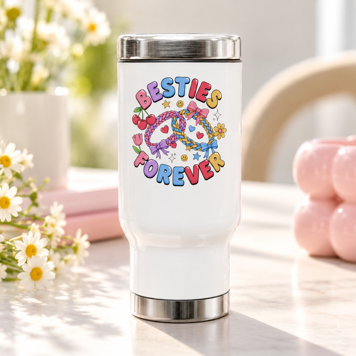 A white stainless steel travel mug with a silver lid and base, printed with "BESTIES FOREVER" in colorful bubble lettering around two linked braided friendship bracelets with bows, hearts, cherries, stars and smiley faces.